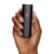 Hand holding a PAX Mini vaporizer to show its size.