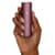 A hand holding a PAX Plus vaporizer to show its size