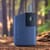 The Wolkenkraft FX Mini Ultra vaporizer in blue colour standing on a piece of wood in a forest